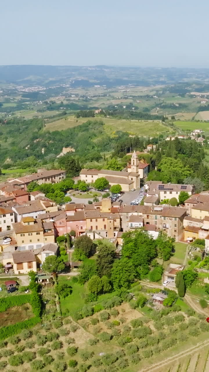Aerial portrait shot around the Marcialla town, summer day in Tuscany, Italy
