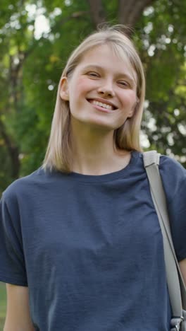 young woman smiling in a park