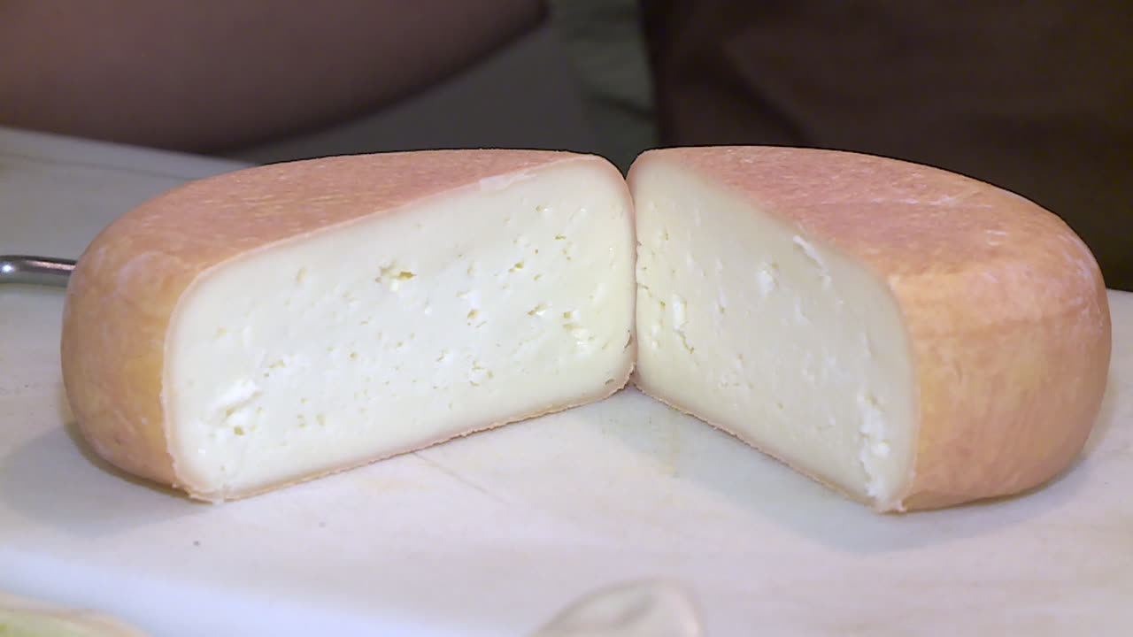 Close-up view of a sliced round cheese