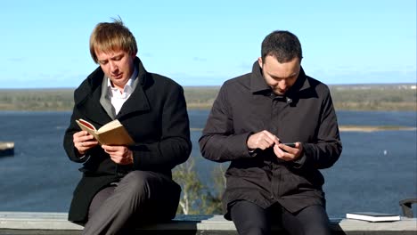 two business people with phone and book