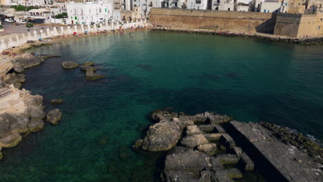 flying towards monopoli town in apulia region, italy - drone shot