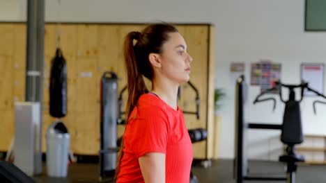 woman exercising with barbell in a fitness studio 4k