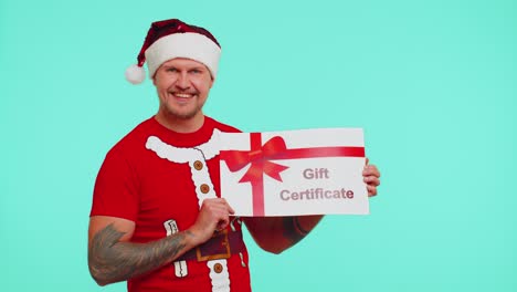 Man-in-red-t-shirt-Santa-Christmas-hat-presenting-card-gift-certificate-coupon-voucher-for-winner