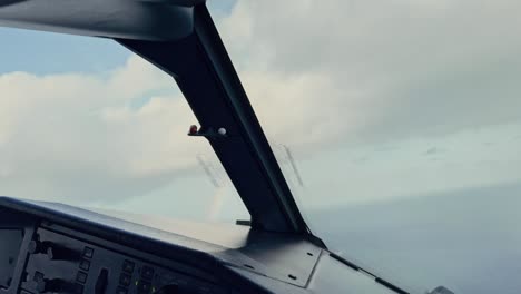 rainbow seen from an aircraft cockpit turning in flight