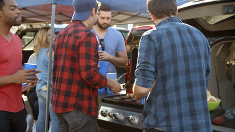 slow motion shot of sports fans tailgating in parking lot