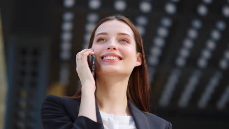 Laughing-woman-calling-mobile-phone-outdoors.-Successful-girl-using-cellphone.