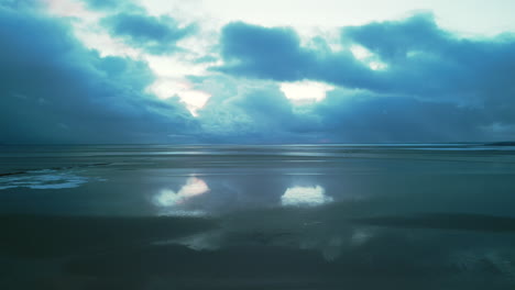 Cloud-reflections-on-wet-sand-with-stormy-sky-at-Jenny-Brown's-Point-Silverdale