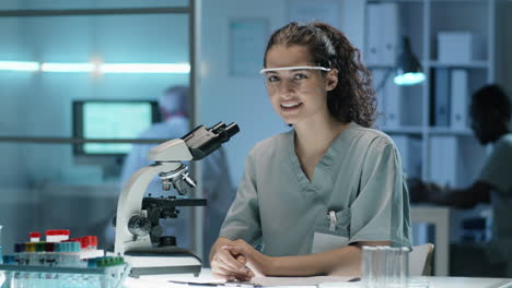 Portrait-of-Young-Cheerful-Woman-at-Work-in-Lab