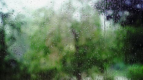 Wet-windowpane-on-rainy-day-with-garden-view