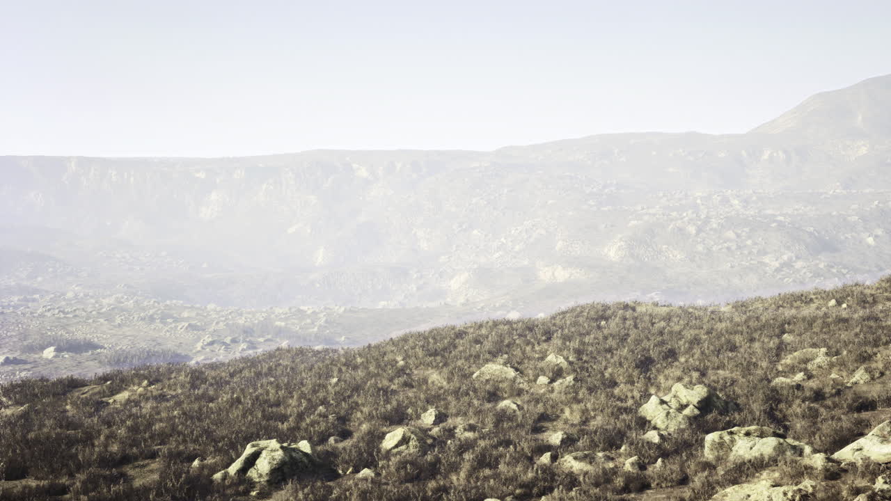 Stunning landscape of rolling hills and rocky terrain under a clear sky