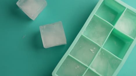Empty Teal Silicone Ice Tray with Ice Cubes