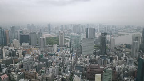 aerial scenic urban drone footage of buildings and skyscrapers in downtown tokyo in the capital city of tokyo, japan