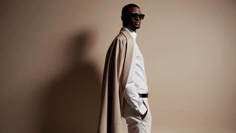 stylish man in sunglasses and beige jacket portrait series