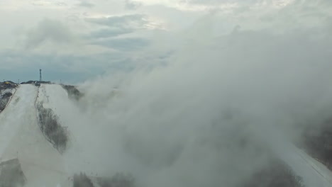 aerial view of phoenix pyeongchang ski resort shrouded by thick fog and clouds