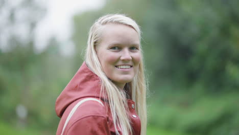 beautiful woman smiling as she walks away unto garden path - slow motion medium shot