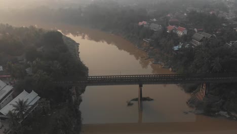 Wide-view-of-old-bridge-in-luang-prabang-province-Loas,-aerial