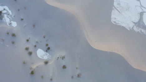 drone slowly ascends to reveal sand dunes in the death valley