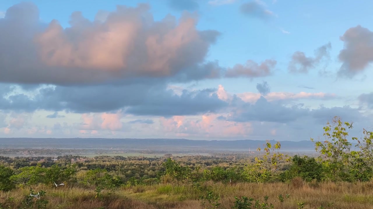 Scenic View of Lush Valley Under Dramatic Sunset Clouds