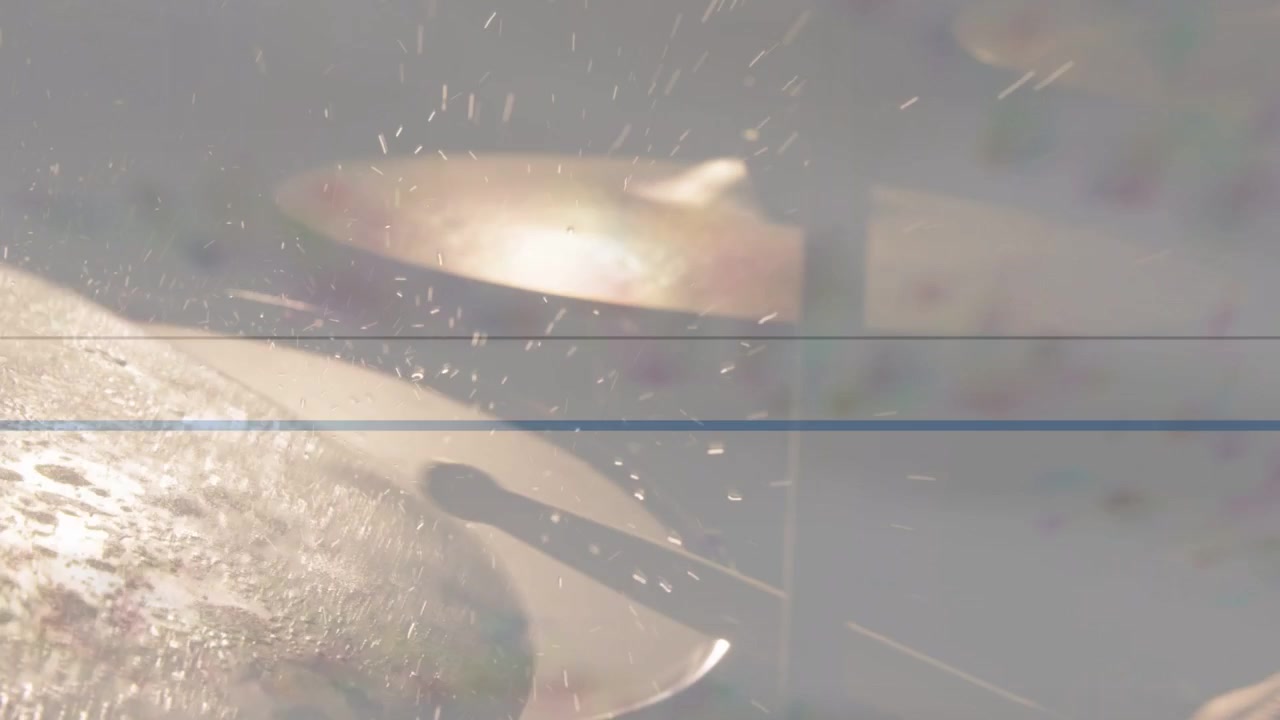 Near cymbal vibrating from backlight flare, droplets shifting, banding showing texture for music