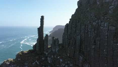 the giants causeway lies at the foot of the basalt cliffs along the sea coast on the north shores of county antrim