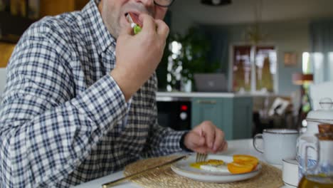 man having breakfast at home