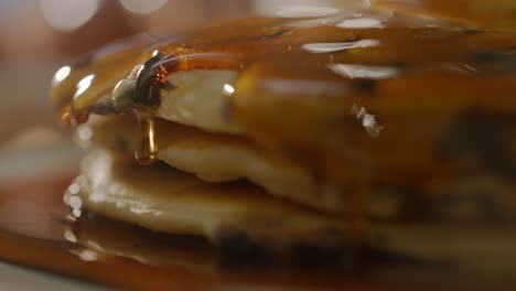 golden syrup dripping over stacked homemade pancakes