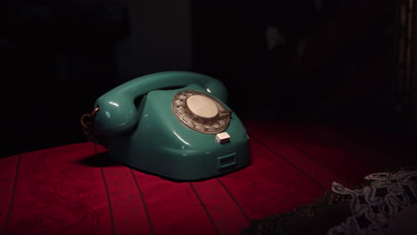 the camera is slowly moving away from the dial phone placed on the table in the retro interior