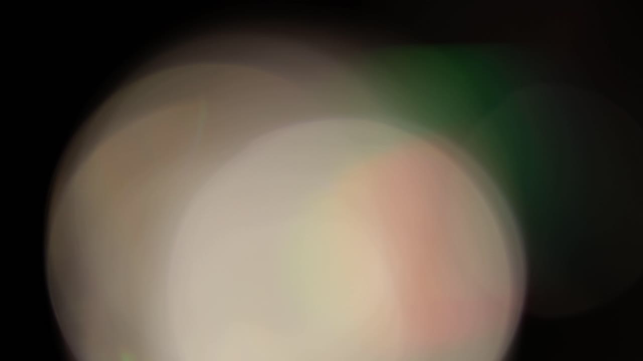 Multicolored light leaks 4k footage on black background. Stylizing video, transitions. Bokeh effect