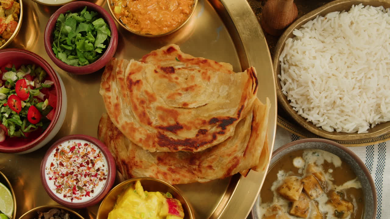 Close-up view of a delicious spicy curry served in a colorful bowl with a spoon, ready for a tasty meal.