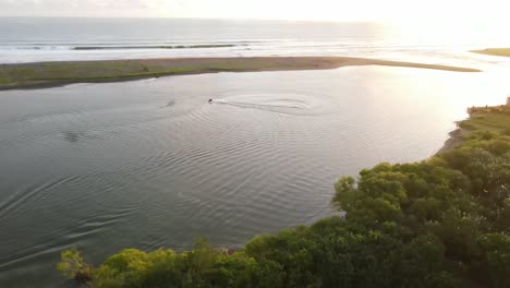 the-aerial-view,-the-motorboats-cruising-in-the-lagoon-at-sunset-look-very-beautiful