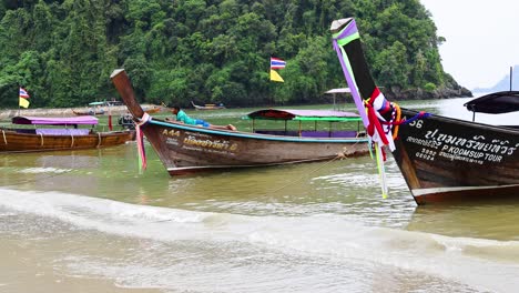 longtail boats at a tropical beach in thailand