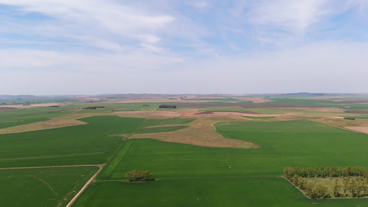 Aerial footage of brown and green plantations, fields of agriculture on a cloudy day, slow motion, copy space