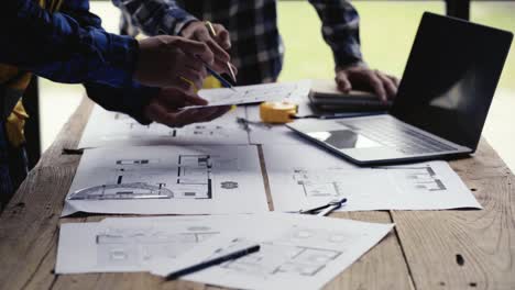 civil engineering team along with the architect and foreman watching the blueprints check the house designs for home building and construction planning 4k video.