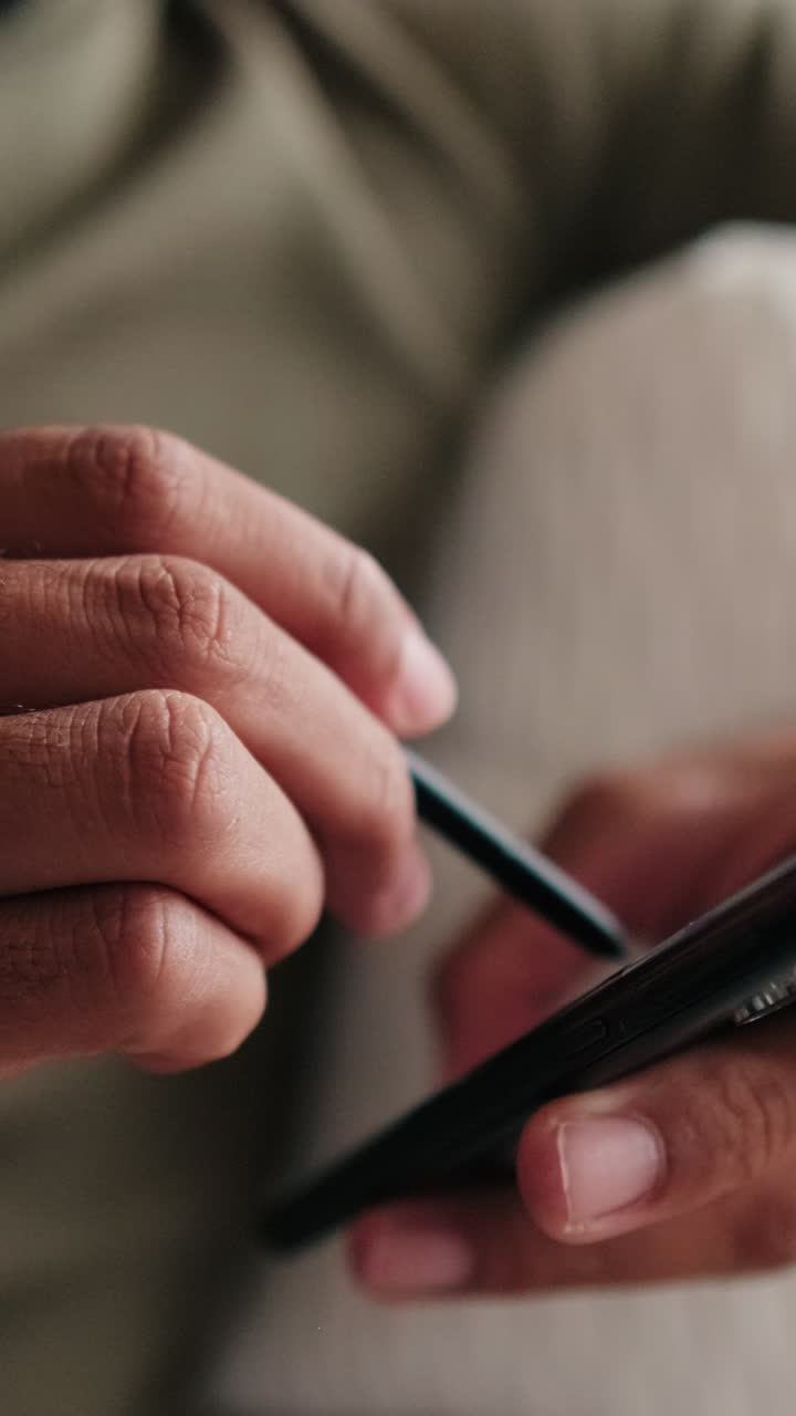 Couple At Home: Man Using Phone Stylus