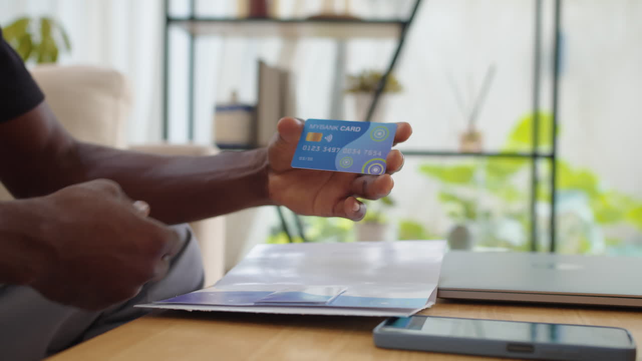 Hands of Man Taking Credit Card out of Envelope