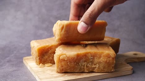 close-up of jaggery blocks on a wooden board