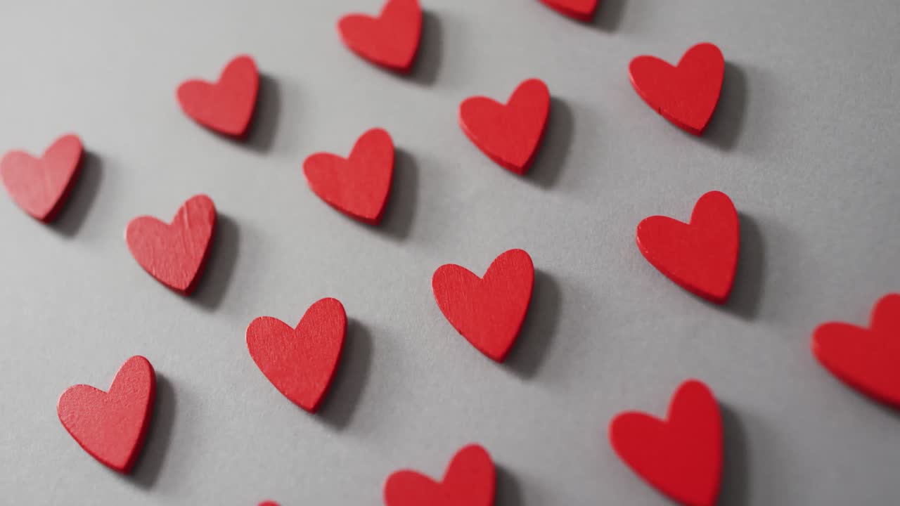 Red wooden hearts on gray background at valentine's day