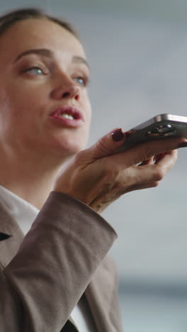 woman using smartphone as microphone