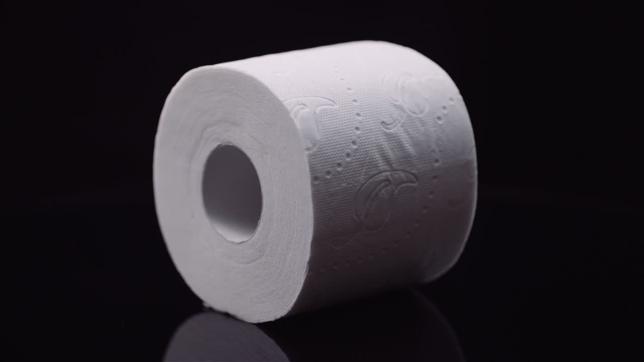 Toilet Paper Isolated on Black Background Rotating.