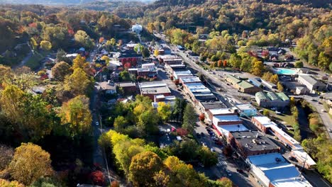 aerial-over-treetops-into-sylva-nc,-north-carolina-in-fall