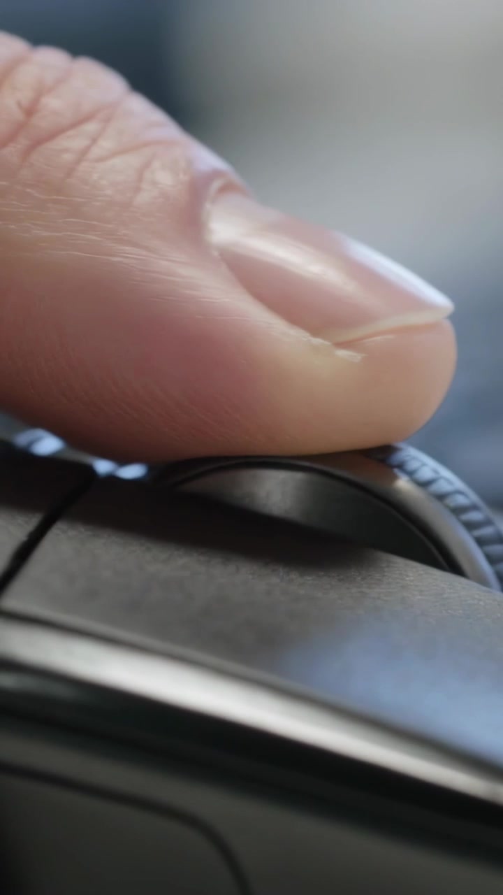 Vertical video: Contacting fingertip rolling mouse wheel on desk in office, scrolling content