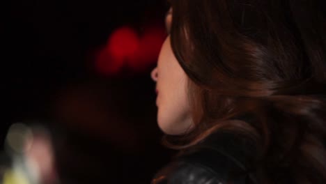 woman drinking wine in a dark bar