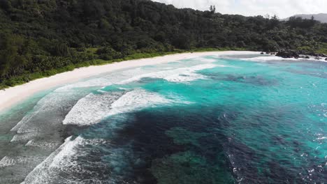 Aerial-view-of-the-white-beaches-and-turquoise-waters-at-Anse-Coco,-Petit-Anse-and-Grand-Anse-on-La-Digue,-an-island-of-the-Seychelles