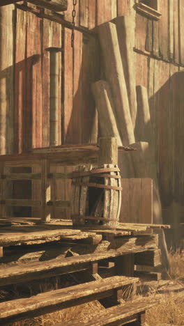 an old wooden barn with a wooden barrel on the porch