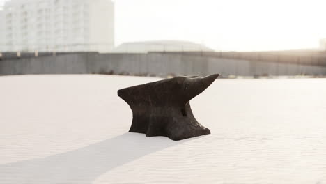 Old-anvil-on-a-sandy-beach