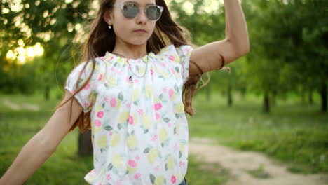 serious teenage girl dancing outside. girl making rhythmical movements outdoors