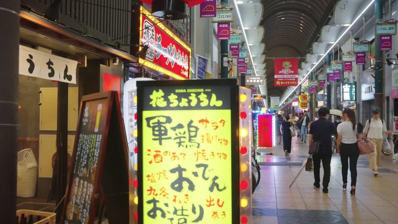 Night life area of Temma in central osaka city, slow motion pan from left to right through arcade