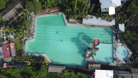 high angle video view of family enjoying backyard swimming pool