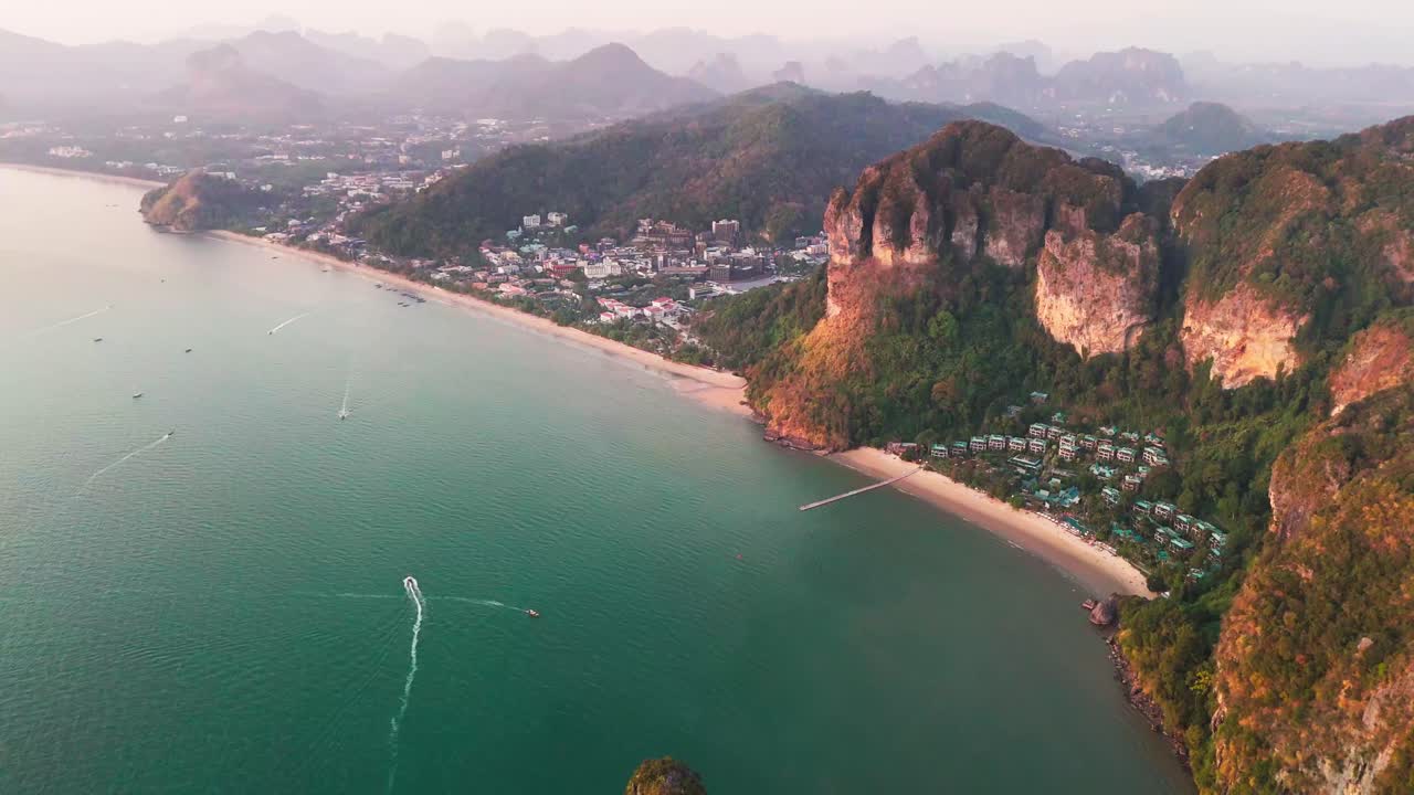 Aerial sunset view of Krabi southern Thailand Ao Nang resort town beach limestone cliff resort hotel