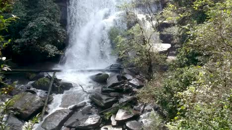 Drone-footage-of-waterfall-in-Chiang-Mai,-Thailand,-with-between-the-trees